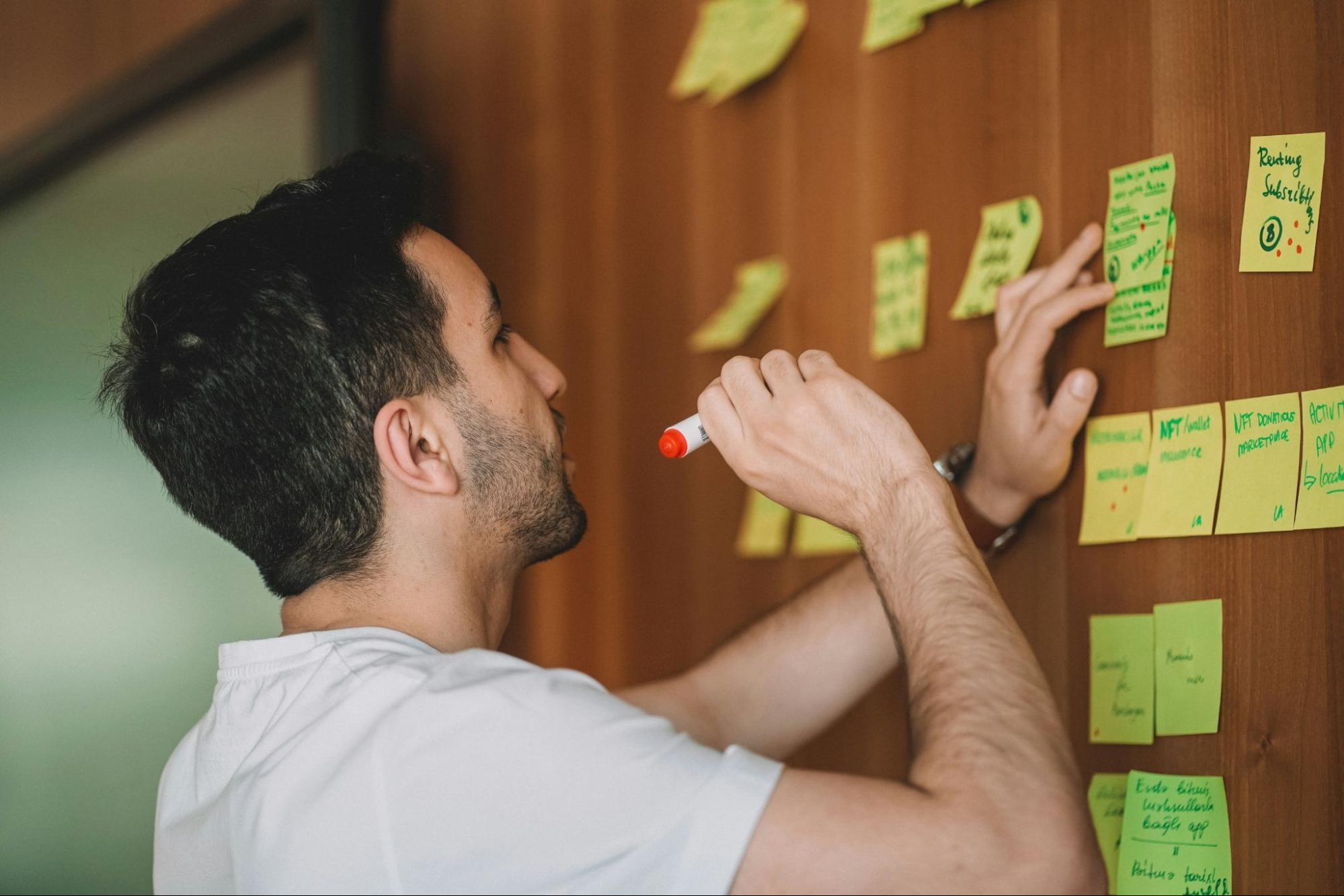 Person writing on sticky notes